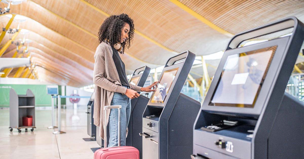 Passenger using self-check-in kiosk for Singapore Airlines flight.